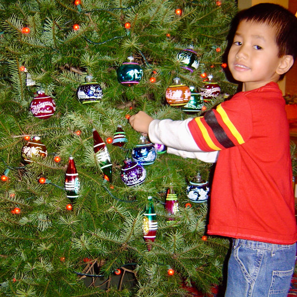 image of child decorating a Christmas tree at home