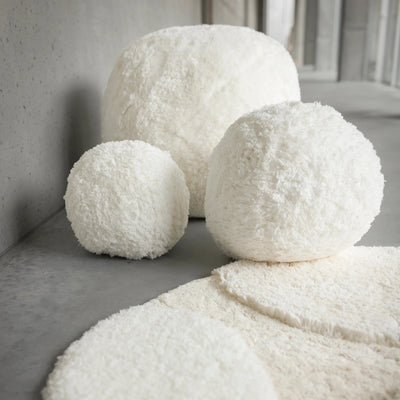 Abyss ivory shearling round poufs in small, medium, and large with matching rug.