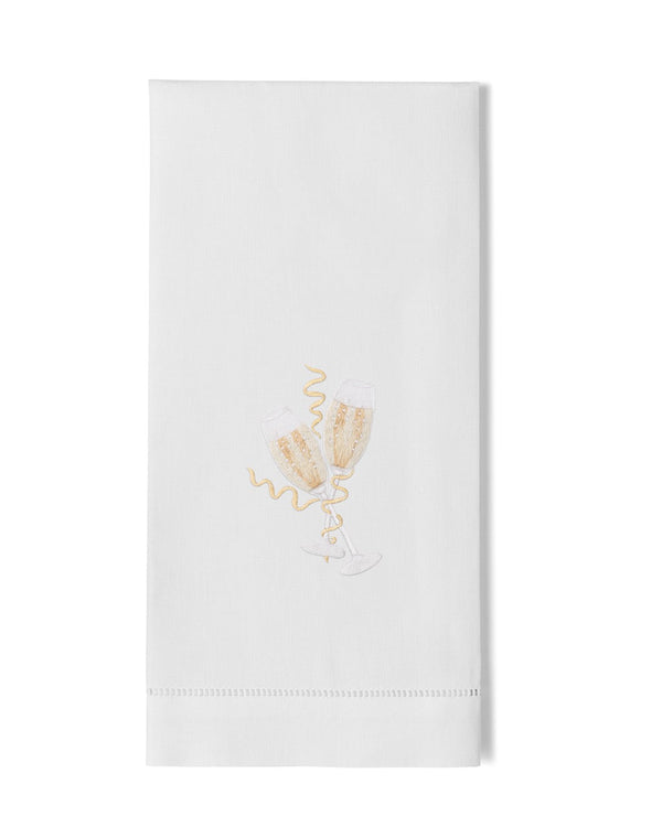 White linen hand towel with gold embroidered champagne flutes and hemstitch border.