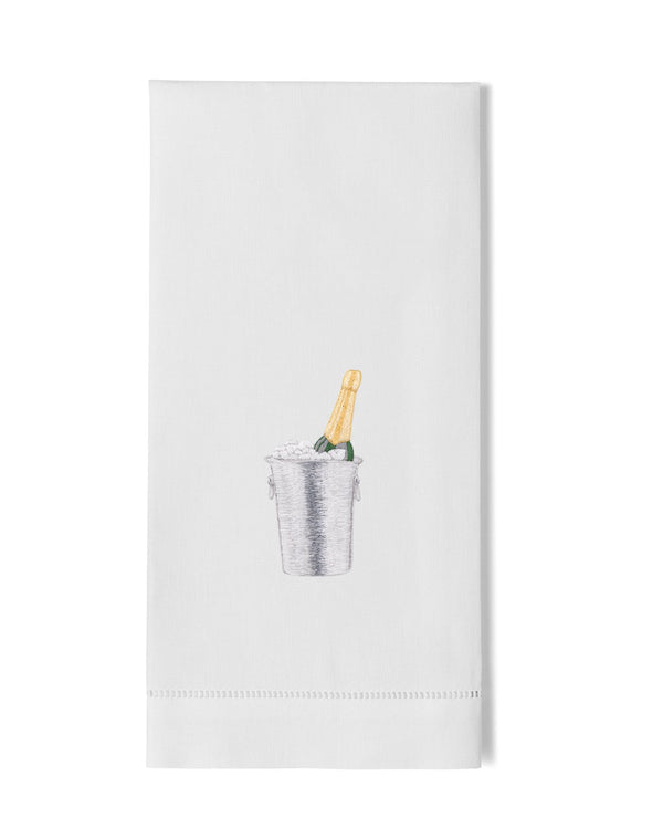 White linen hand towel with embroidered champagne bottle in ice bucket motif.