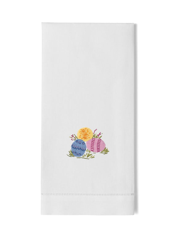 White linen hand towel with embroidered Easter eggs in yellow, blue, and pink.