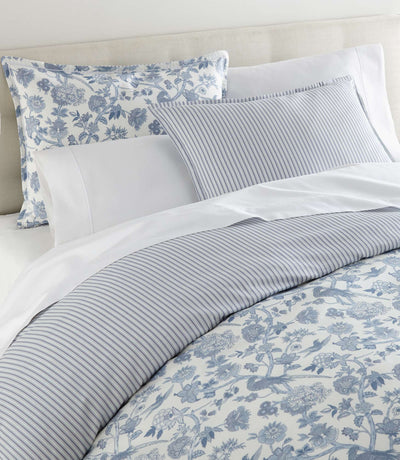 Windsor Highgrove blue floral and stripe cotton bedding set styled on a made bed.