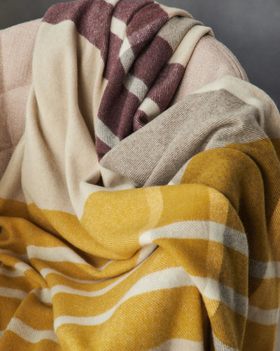 Lanerossi Everest Check throw in mustard, mauve, and sand plaid, draped in soft folds.