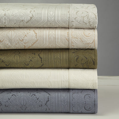 Sferra Olympia bedding stacked in ivory, champagne, olive, cream, and slate damask.