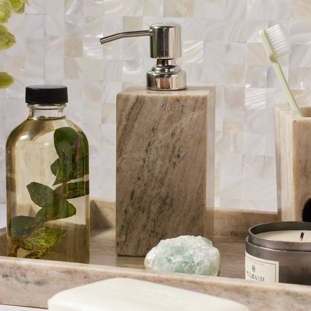Athlone marble soap dispenser styled on a tray with bathroom accessories.
