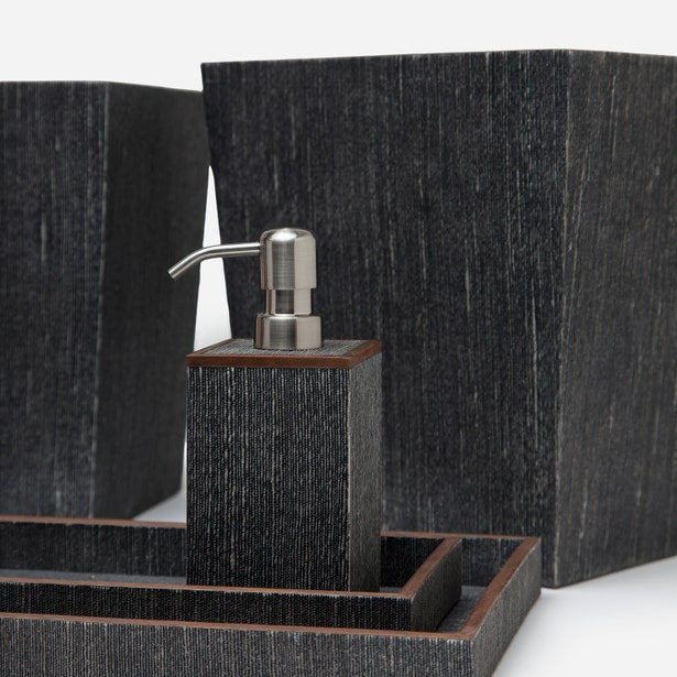 Dark textured bath accessories set with soap dispenser, tray, and containers in charcoal finish.