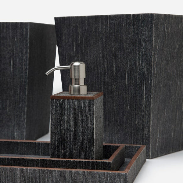 Dark textured bath accessories set with soap dispenser, tray, and containers in charcoal finish.
