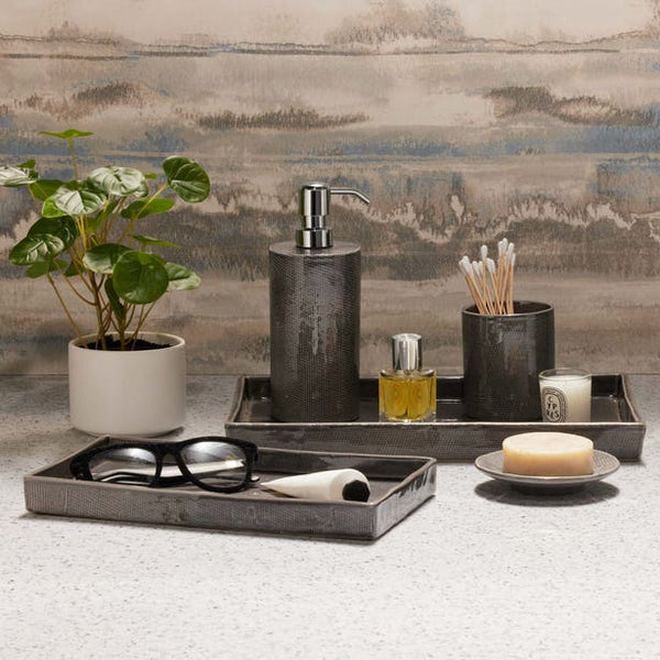 Cordoba bath accessory set in charcoal, styled on counter with tray, soap dish, and dispenser.