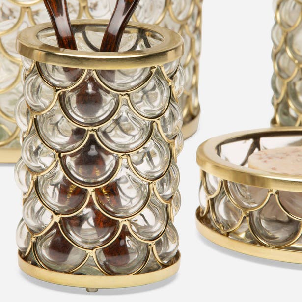 Gold and glass fish scale bath accessories set with cylindrical holder and lidded dish.