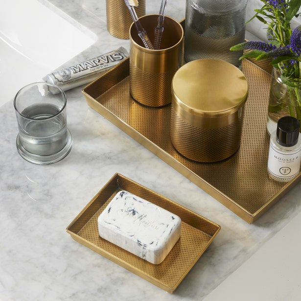 Hagen Bath brass textured tray set styled on marble with soap dish and accessories.