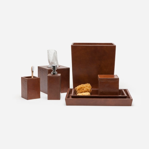 Hampton bath accessory set in cognac leather, including tray, bin, and dispenser.