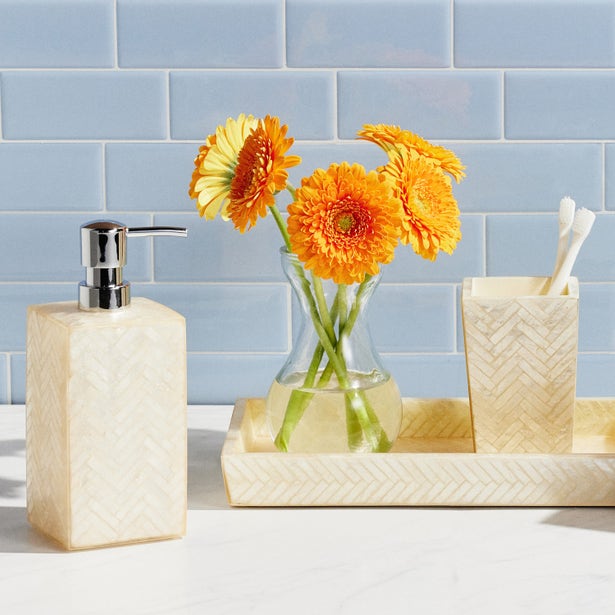 I need the vendor/brand name to complete the alt text. Could you provide the vendor for this product? In the meantime, here's a placeholder:

Handa ivory herringbone bath accessories set styled on white counter with orange florals.