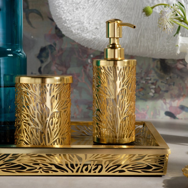 Lynn gold bath accessories set with filigree detail: soap dispenser, cup, and tray.