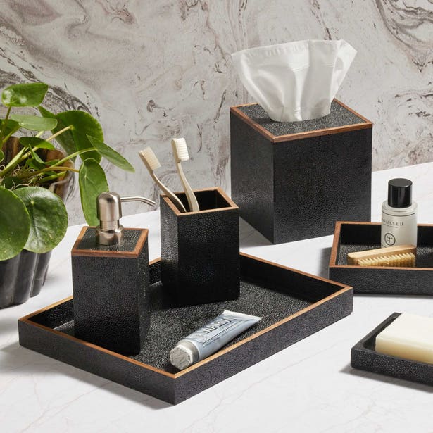 Manchester bath accessories set in black shagreen with cognac trim, styled on marble surface.