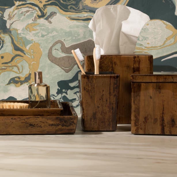 Varadero bath accessories set in dark wood, styled on marble surface against marbled wall art.