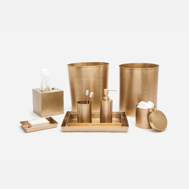 Verum hammered gold bath accessory collection arranged on white background.