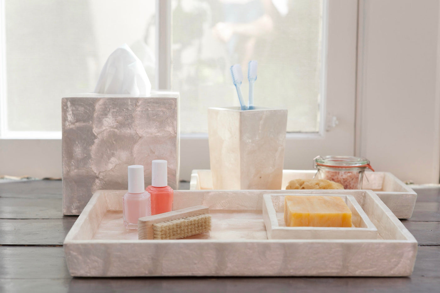 Andria bath accessories in stone finish, styled tray with tissue box and toothbrush holder.