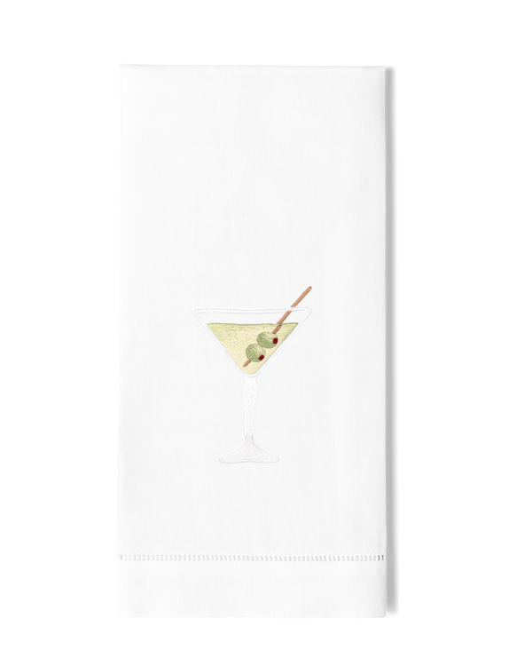 White linen guest towel with embroidered martini glass and olive motif, hemstitched border.