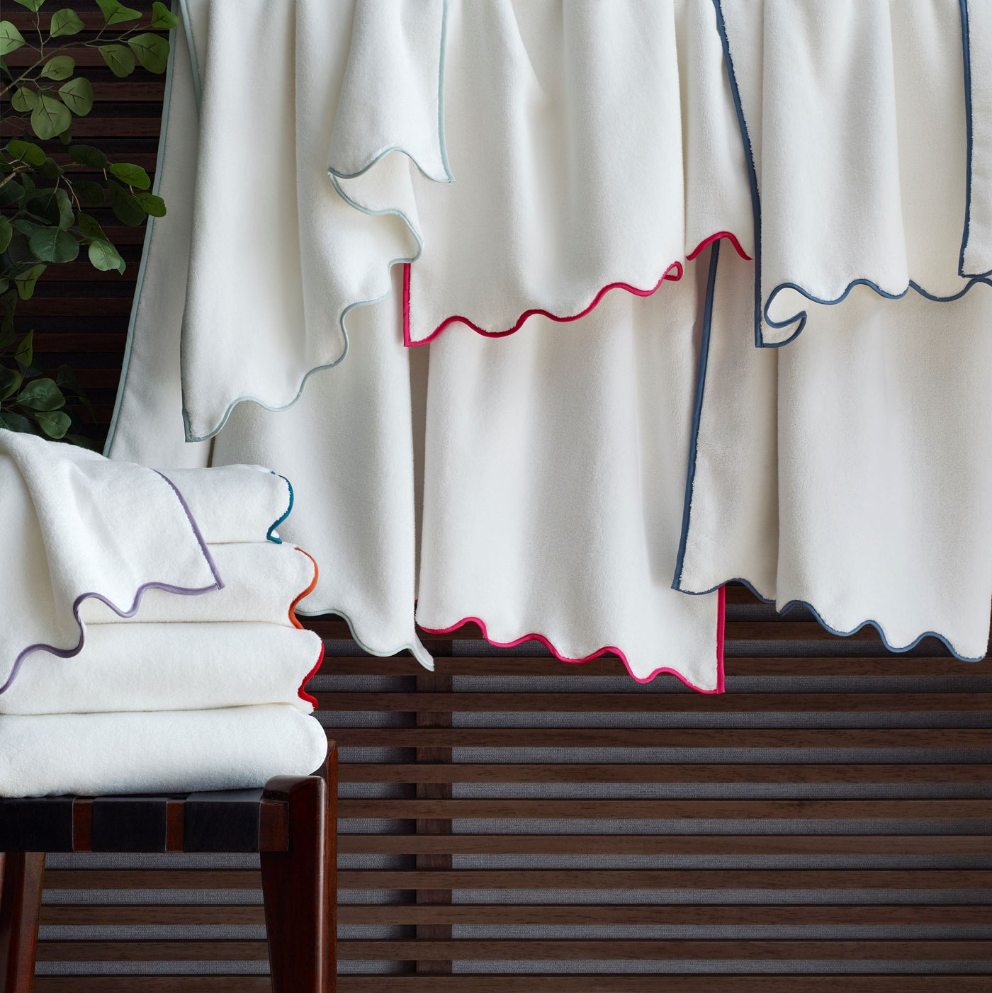 Antalya ivory bath linens with scalloped edges in pink, navy, and lavender trim.
