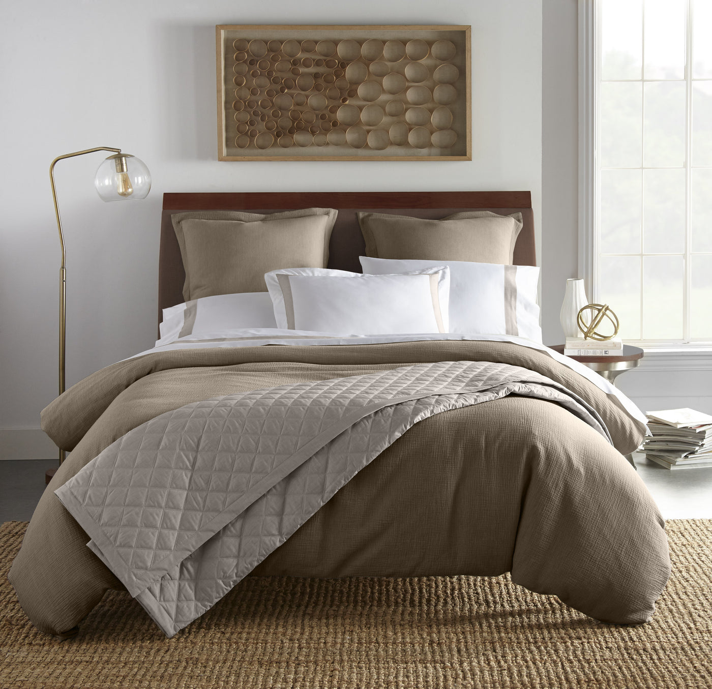 Atacama taupe linen duvet cover with quilted stone coverlet on made bed.