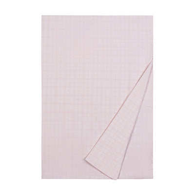 Camden blush cotton flat sheet with subtle grid weave pattern, corner folded back.