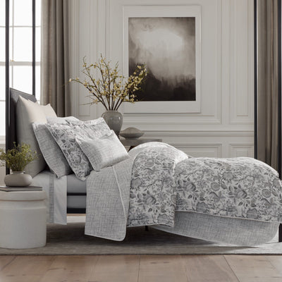 Daphne grey floral bedding set with textured coverlet on a styled bed.