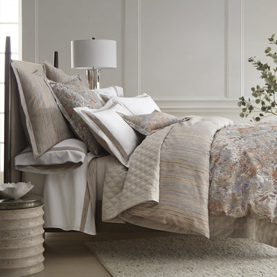 Sferra Giverny floral bedding in blush and taupe tones on a styled bed.