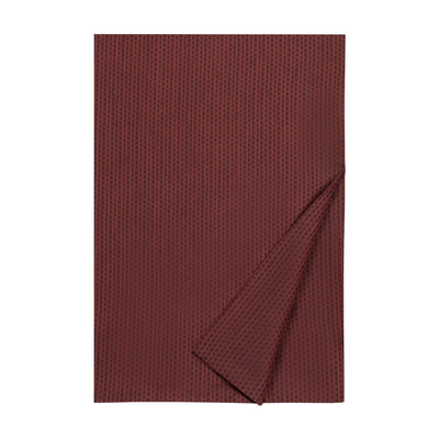 Heritage crimson waffle-weave bedding piece with folded corner detail.