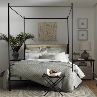 Jacqueline bedding collection in sage and ivory on black four-poster canopy bed.