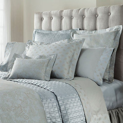 Sferra Kashan bedding collection in mist blue jacquard with medallion pattern on styled bed.
