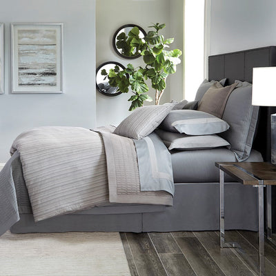 Sferra Leonardo charcoal and silver gray bedding collection on styled bed.