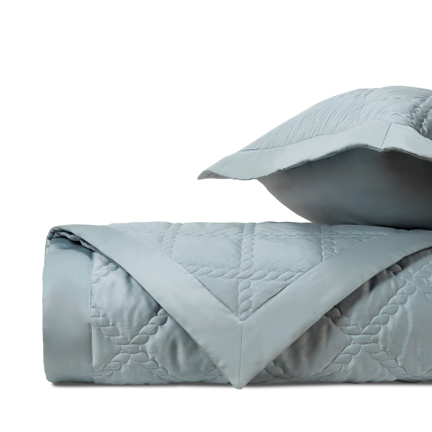 Liberty quilted bedspread and sham in mist blue with geometric stitching pattern.