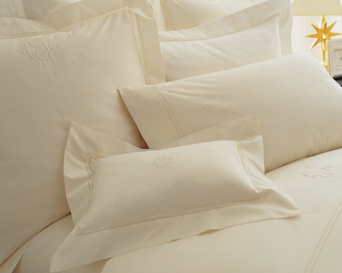 Luxury bedding collection Lyric cotton percale shams and cases in ivory on plush bed