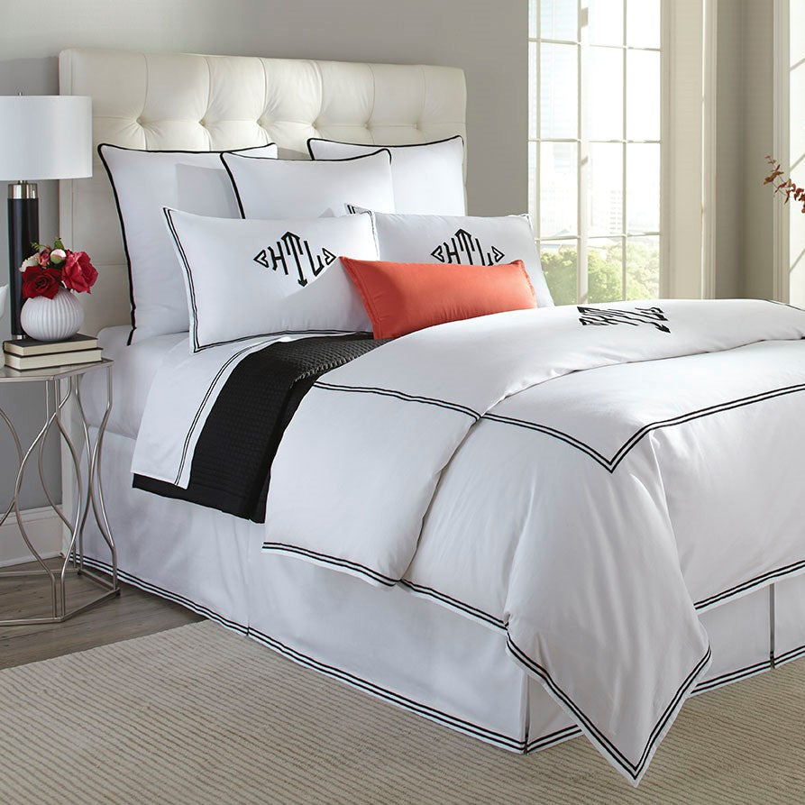 Madison bedding collection in white with black double-stitch border on bed.