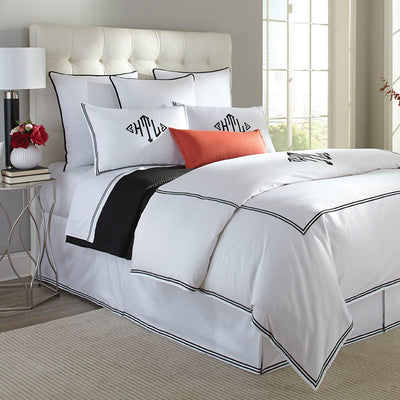 Madison bedding collection in white with black double-stitch border on bed.