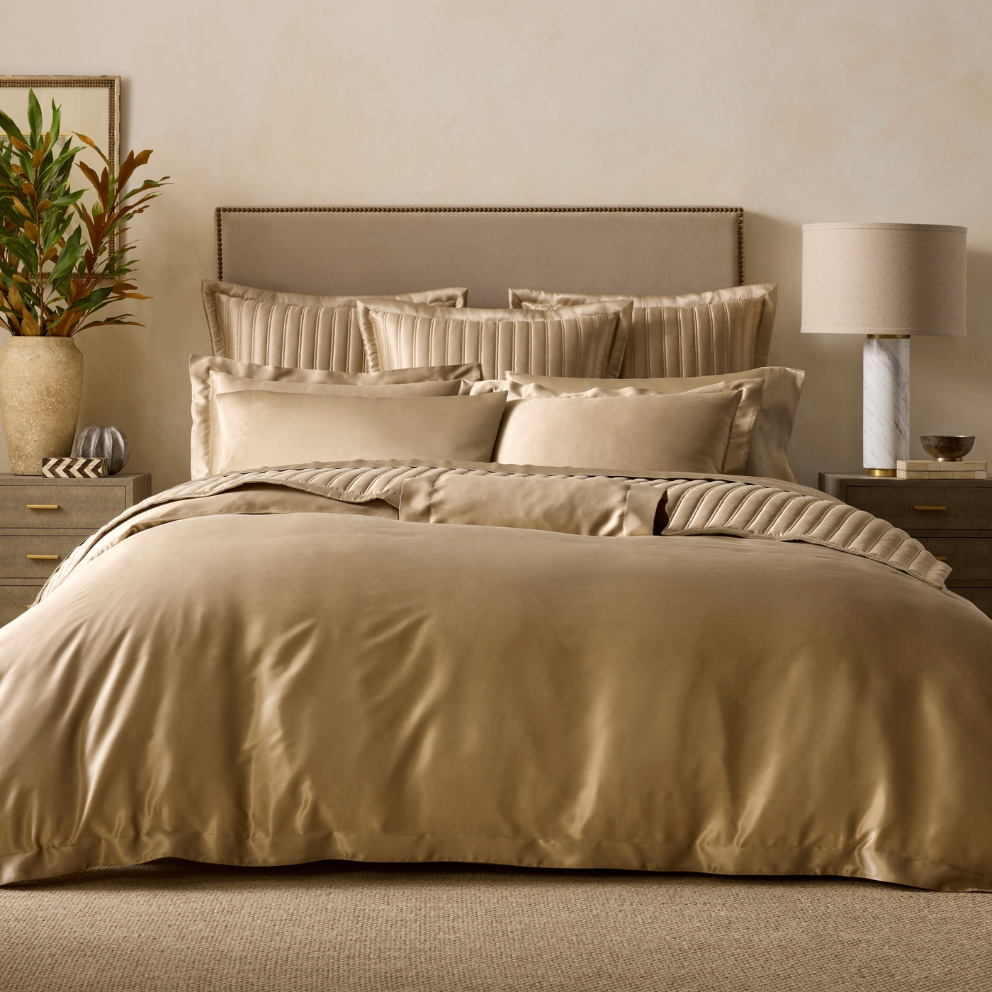 Sferra Mulberry champagne silk duvet cover and shams on styled bed.