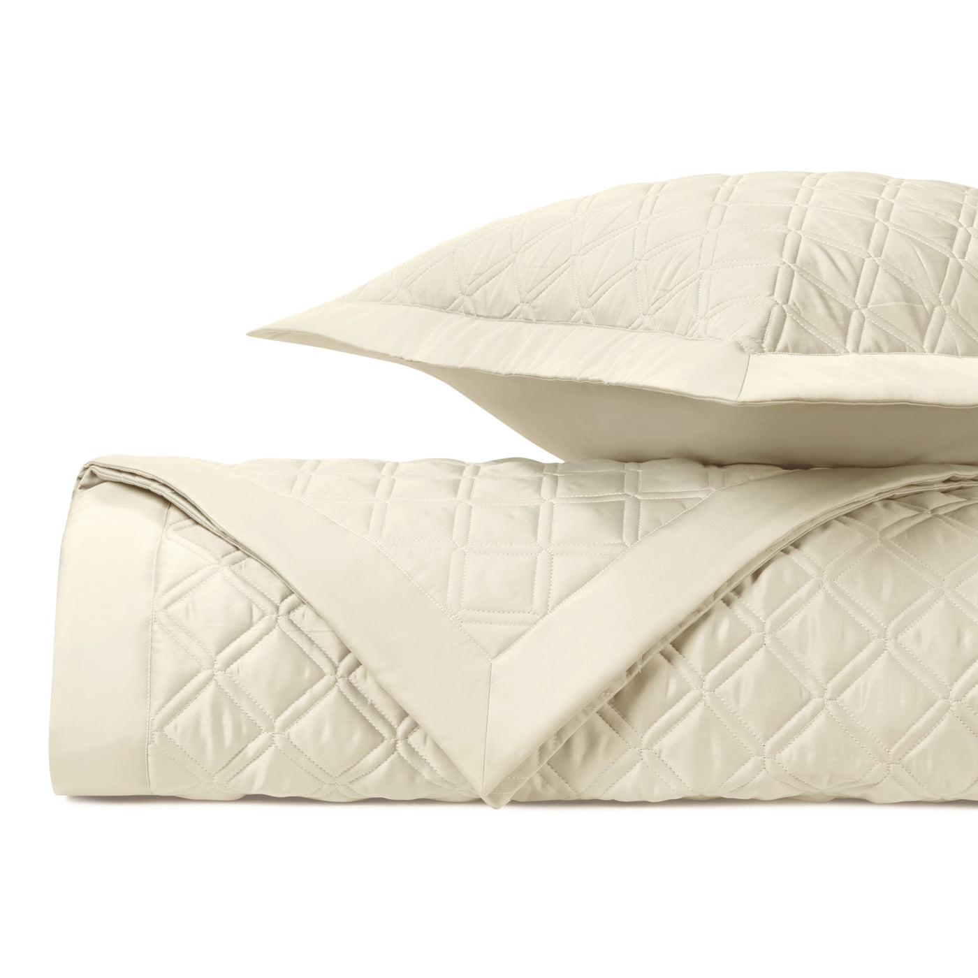 Renaissance ivory quilted coverlet and sham set with diamond stitching, neatly folded.