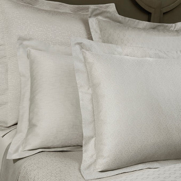 Home Treasures Scotland ivory jacquard pillow shams and bedding styled on a bed.