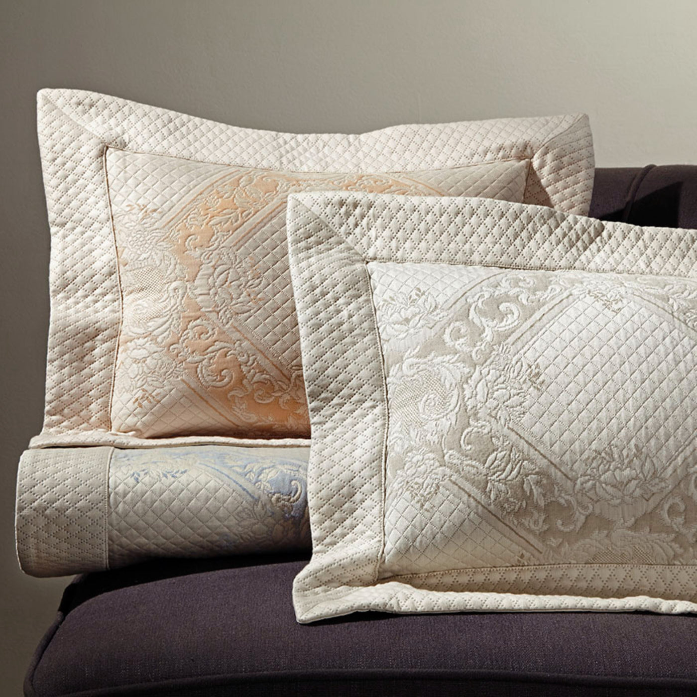 Sferra Shiraz quilted pillow shams in ivory and champagne with ornate embroidered medallion detail.