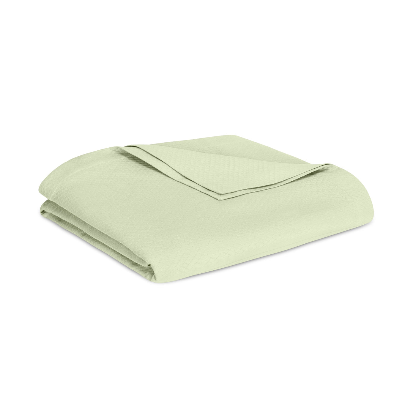 Sferra Sierra blanket folded in sage green with subtle woven texture.