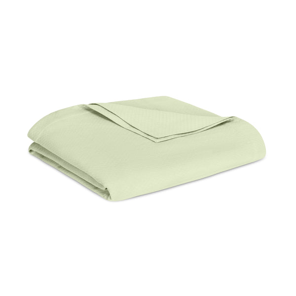Home Treasures Sierra blanket folded in sage green with subtle woven texture.