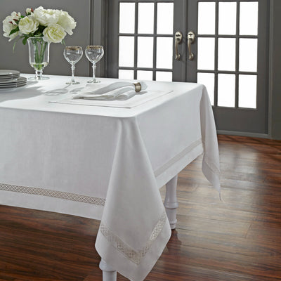Valencia white linen tablecloth with lattice hemstitch border on a set dining table.