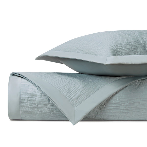 Wave matelassé coverlet and sham in spa blue with textured woven pattern.