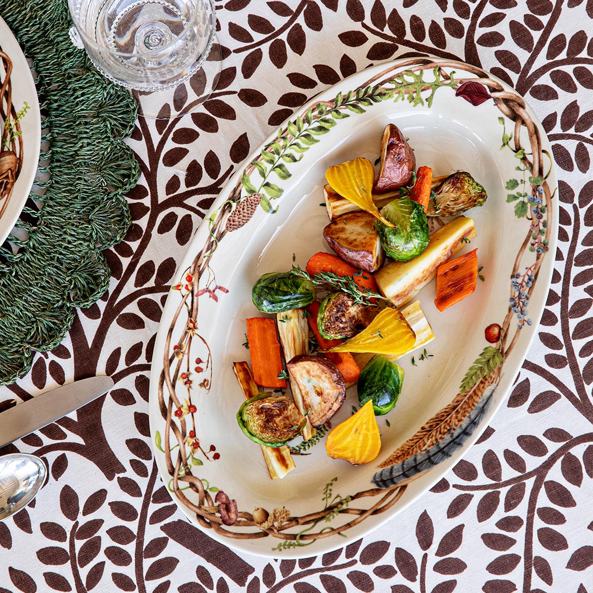Forest Walk Gratitude platter of roasted vegetables on a brown and white leaf print tablecloth