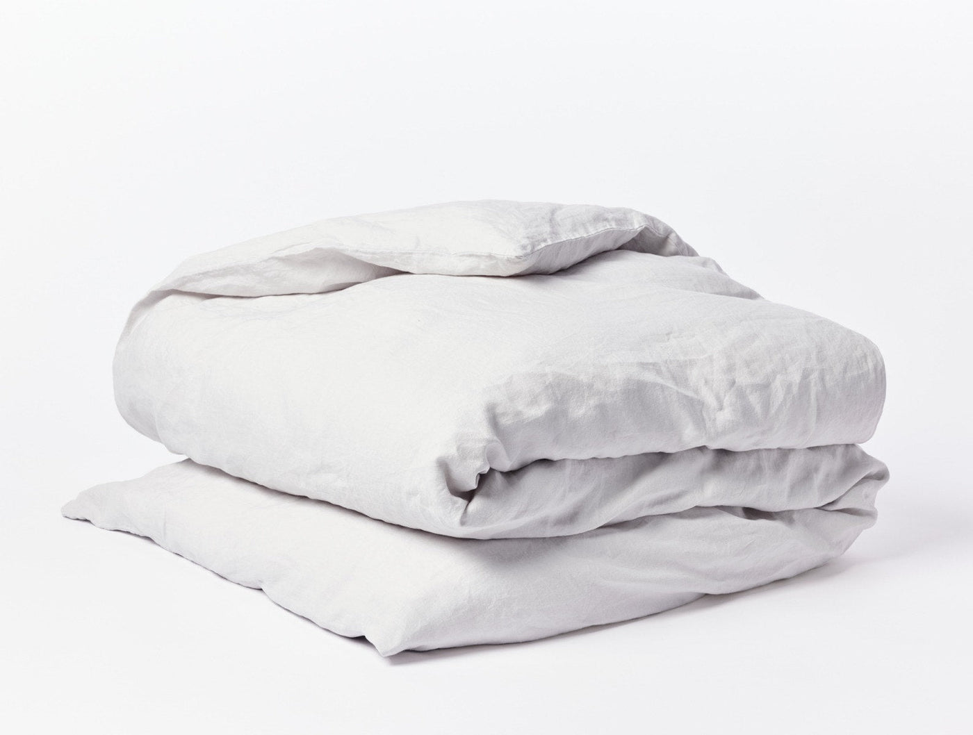 Coyuchi Relaxed Linen duvet cover folded, shown in soft silver-grey against white background.