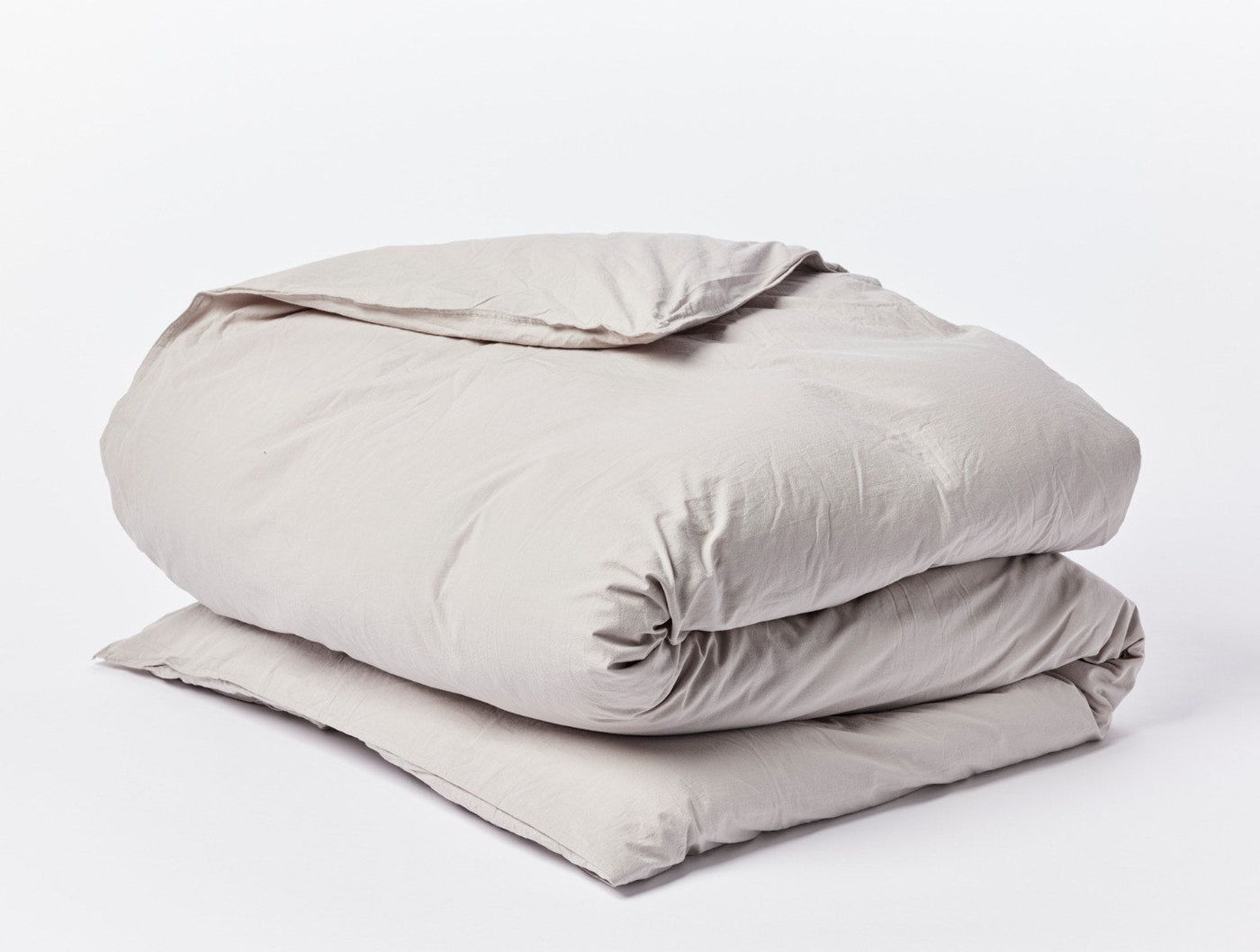 Coyuchi Crinkled Percale duvet cover in taupe, neatly folded to show texture.