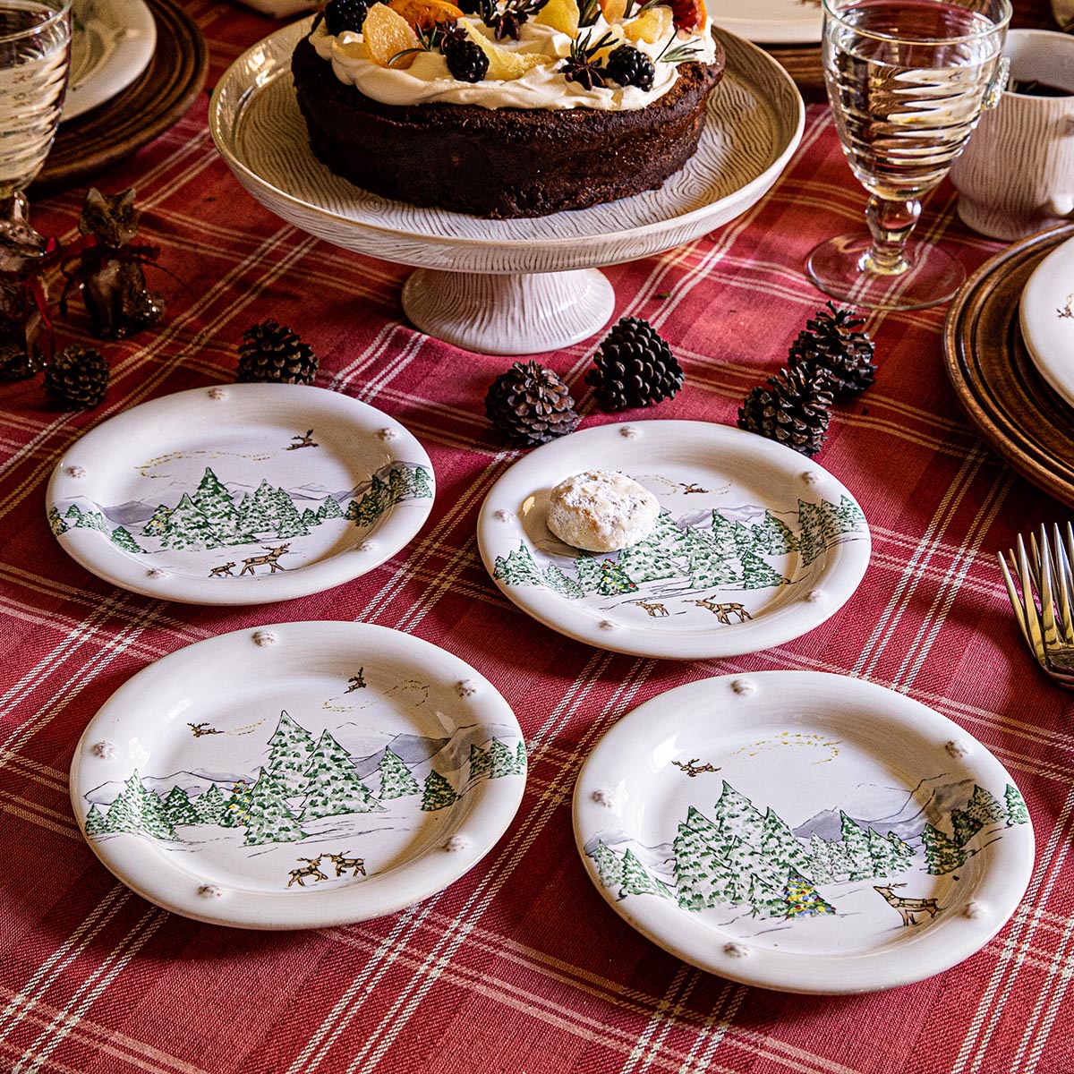 North Pole side plates around a chocolate cake on a red plaid tablecloth