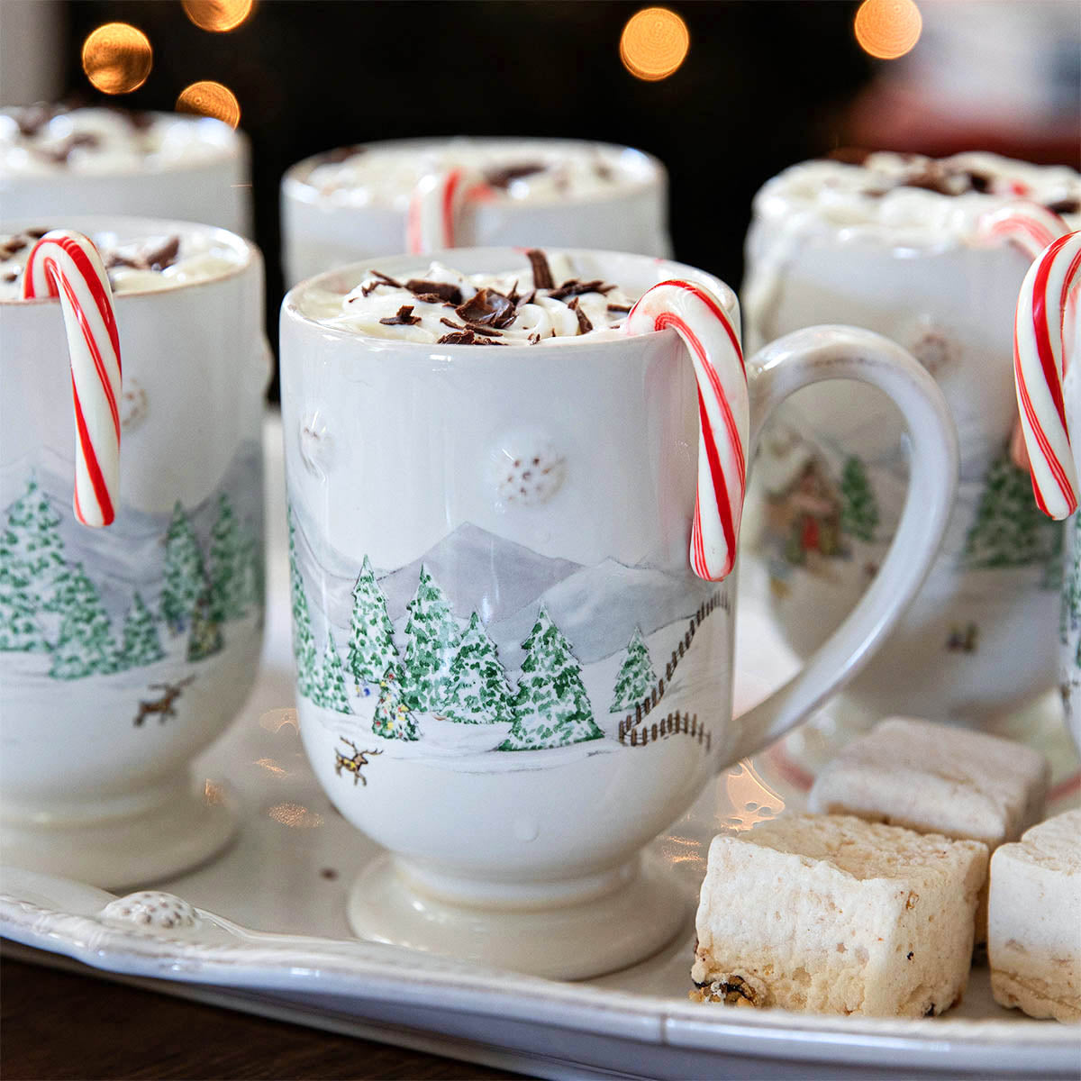 North Pole mugs of hot cocoa with candy canes and marshmallows