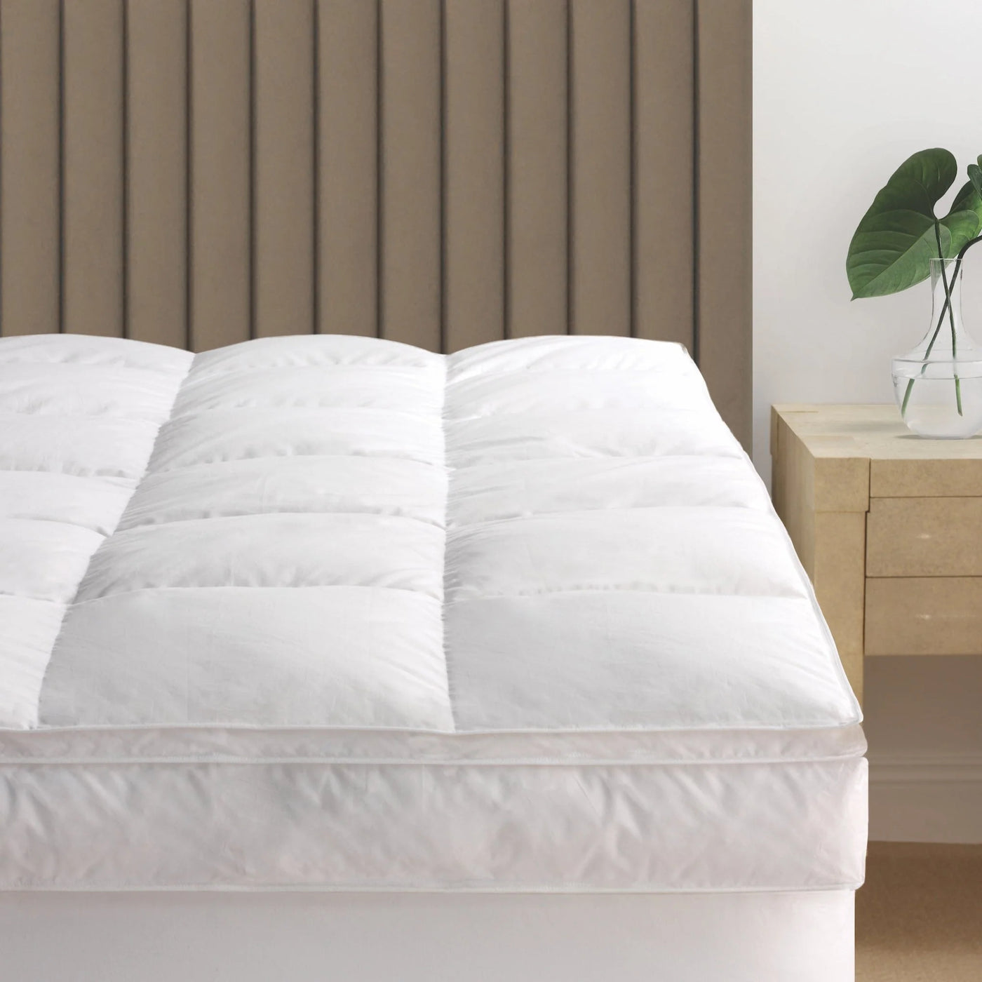 Scandia Home white quilted down featherbed topper on a bed, plush and thick.