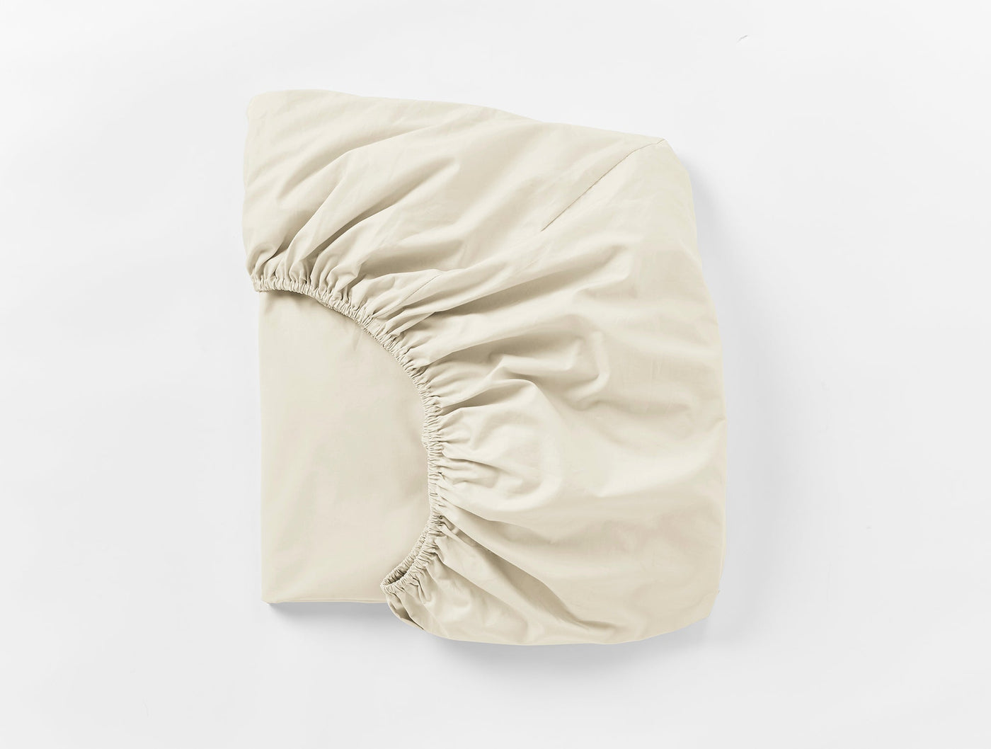 Ivory fitted sheet folded to show elasticated corners and smooth percale weave.